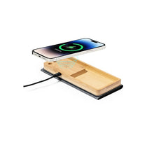 Wooden wireless charging pad with a smartphone on a white background