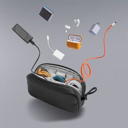 Open black carrying case with electronic accessories on a gray background