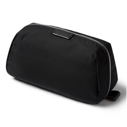 Black toiletry bag with zipper on a white background